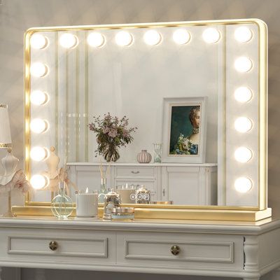 This lighted Hollywood mirror brightens any space with its built-in LED lights. It boasts a rectangular silhouette that works horizontally. This mirror has a metal frame that features curved corners and beveled edges for a retro, vintage-inspired feel. It's rated for damp or dry environments, working equally well in your bedroom, bathroom, or powder room. The included LED bulbs are dimmer-switch compatible for creating the right ambiance, day or night. Finish: Gold, Size: 24" x 32" | House of Ha Hollywood Light Mirror, Dorm Vanity, Makeup Desks, White Vanity Mirror, Gold Vanity Mirror, Bulb Mirror, Night House, Hollywood Makeup Mirror, Gold House