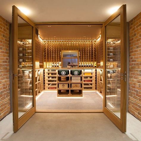 This wine room is truly magnificent! Behind the two glass doors this area holds an enormous 1500+ bottles and is a beautiful space. Either side of the door, acrylic rods create translucent shelving for a bottle display. Behind the entrance, bottles are stored within the enclosed environment, softly lit with integrated LED lighting. Guest Bedroom Office, Rooms Luxury, Custom Wine Rack, Wine Rooms, Home Wine Cellars, Custom Wine Cellars, Acrylic Rod, Wine Cellar Design, Cellar Design