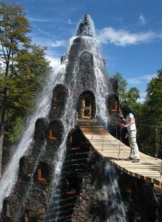 The Magic Mountain Hotel is located in Huilo Huilo, in Los Rios, Chile. The main feature of this Hotel is it's unique design. One more thing is that visitor enter in this hotel on a suspended rope bridge. Unusual Hotels, Mountain Hotel, Magic Mountain, Chile Travel, Water Fall, Unique Hotels, Beautiful Places In The World, Oh The Places Youll Go, Places Around The World