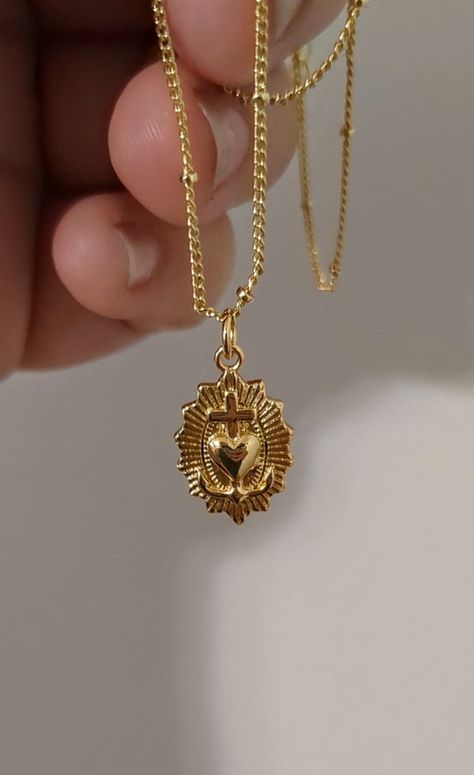 Discover elegance and spiritual grace with our 24k Gold-filled Dainty Sacred Heart Necklace. Delicately crafted and measuring 18 inches in length, this necklace features a beautifully detailed Sacred Heart pendant that symbolizes love, devotion, and protection. The intricate design and high-quality materials make it a perfect piece for everyday wear or special occasions, adding a touch of timeless beauty to any outfit. Treat yourself or a loved one to this exquisite blend of faith and fashion, meticulously handcrafted to capture hearts and inspire souls. Item specs as below Measurement: 23.6mm x 12.7mm Material: Brass, 24K Gold Plated Color: Gold Quantity: 1 Piece *Lead and Nickel Free* Hypoallergenic and tarnish-resistant Each piece is lovingly made to order, ensuring a unique and persona Vintage Gold Plated Heart Necklace, Gold Spiritual Heart Necklace, Ornate Gold Heart Pendant Jewelry, Sacred Heart Pendant, Sacred Heart Necklace Gold, Gold Heart-shaped Spiritual Necklace, Sacred Heart Pendant Gold, Sacred Heart Necklace, Vintage Gold Necklace