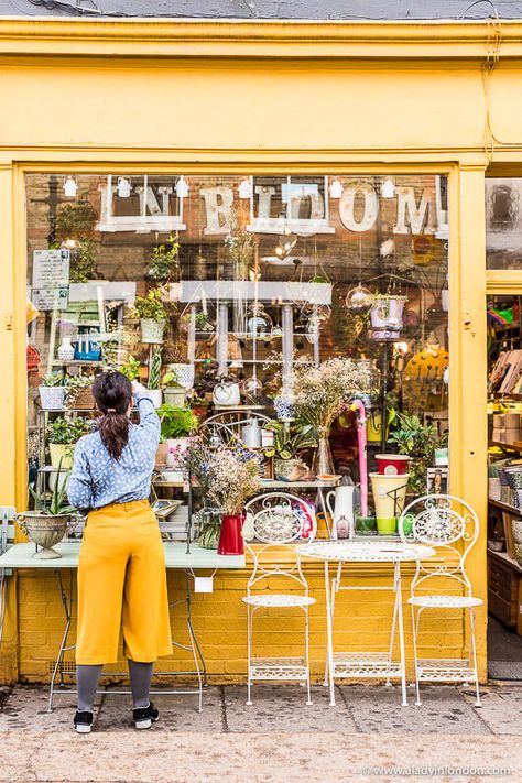 This shop on Columbia Road in London is lovely. The matching yellow culottes are great. The Columbia Road Flower Market in London is one of the best markets in London. A Columbia Road Flower Market Sunday morning is a great experience. This London market is great, and there are a lot of other good London markets too. #london #market #flowermarket #flowers #columbiaroadflowermarket #shop #culottes London Shopping Street, Matilda Aesthetic, Yellow Soul, London Hipster, Yellow Aesthetics, Where To Stay In London, Best Places In London, Yellow Trousers, Columbia Road Flower Market