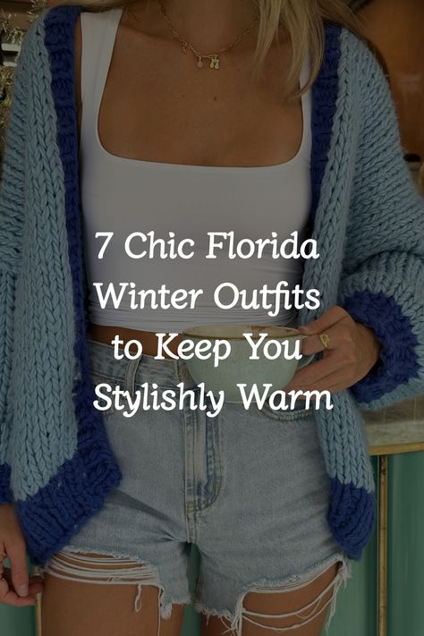 The person is wearing a white crop top, a blue knitted cardigan, and denim shorts. Warm Winter Day Outfit Casual, Cute Outfits Chilly Weather, Trendy Layering Outfits, Fall Outfits Florida Casual, Cold Beach Night Outfit, Cute Florida Winter Outfits, Florida Day Outfits, Outfit Ideas For Florida In December, Florida Outfits Vacation Winter