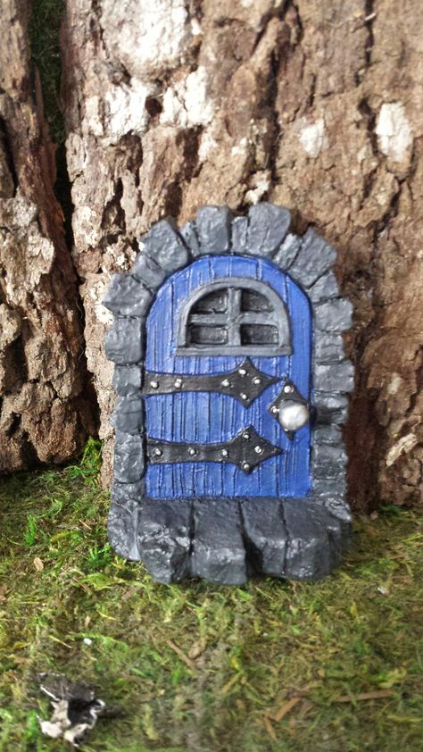 "Please read description fully in regards to measurements/size of item. If you want the fairies to visit your garden, then you simply must provide a Medieval Fairy Door Garden Accent for them. How else could they travel from their magical realm to your home or yard? Our delightfully detailed resin fairy door appears to be made from wood and stone with door knob and hinges. Mount this fairy door to any tree, post or wall, indoors or out, so you can be sure the fairies can find the way from their Fae Crafts, Dungeon Door, Aesthetic Home Design, Door Mouse, Door Gnome, Medieval Fairy, Pixie Doors, Cardboard Sculptures, Fairy Pots