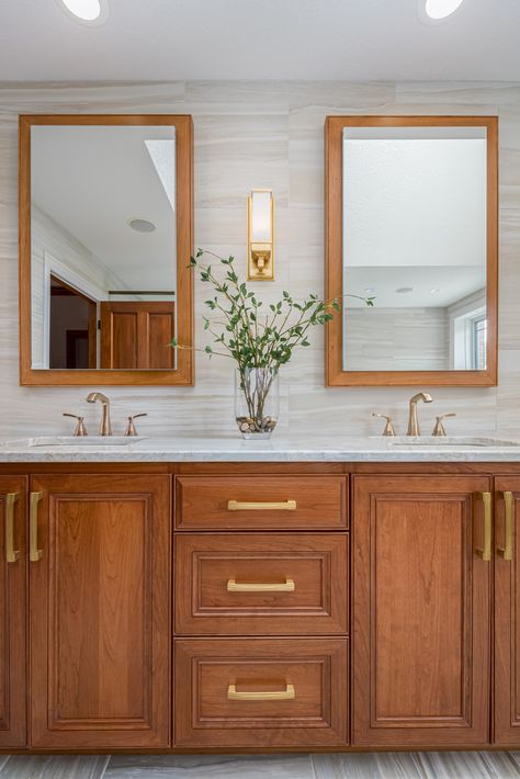 Double vanity cabinet in natural-finish cherry wood with recessed medicine cabinets and custom matching frames. Medium Brown Bathroom Vanity, Red Oak Bathroom Vanity, Bathroom With Wooden Cabinets, Wood Cabinet Bathroom Ideas, Dark Wood Double Vanity, Cherry Cabinet Bathroom, Cherry Cabinets With Gold Hardware, Cherry Vanity Bathroom, Cherry Bathroom Cabinets