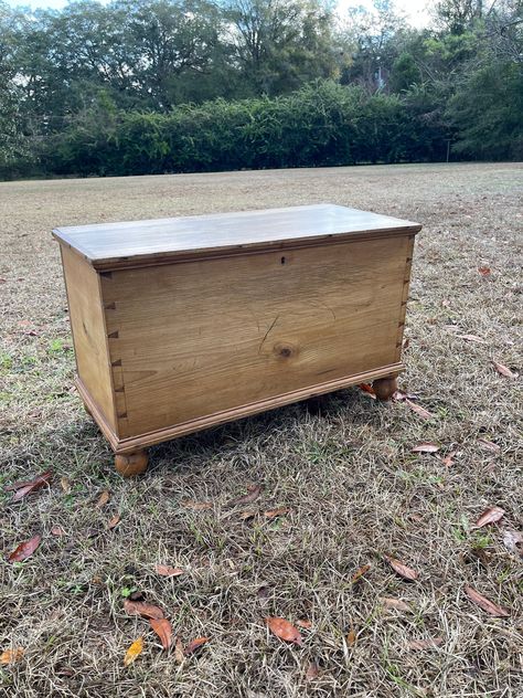 "Antique pine blanket chest with turned  feet. Primitive, rustic great farmhouse decor. Put together with hand made dovetails. Very thick wood planks. I think it's European, not sure. Very sturdy. Box could have many uses--window seat, books, craft supplies, toys, general storage, farmhouse decor, store your blankets, use at the foot of the bed or use it for a coffee table. Very rustic with scratches and dings, look at all pictures and video for description. . This is an awesome piece of history. It has \"the Look\" only time can create! Great patina!  Size- 31\" long x 19.5\" tall x 14.5\" deep. Inside measurements 28\" x 12.5\" x 13.5\" tall" Primitive Blanket Chest, Antique Blanket Chest, Antique Blanket, Coffee Table Rustic, Vintage Trunk, Cedar Box, Chest Bench, Trunk Storage, Antique Booth