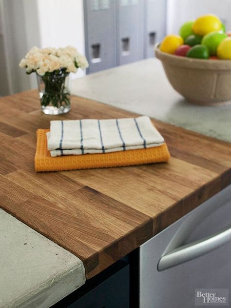 Many homeowners opt to pour their own concrete counters. The materials are inexpensive and require few tools. These homeowners ran out of concrete so they added this inset of butcher block to their island, creating a beautiful juxtaposition./ Polished Concrete Countertops, Concrete Countertop Ideas, Butcher Blocks, Kitchen Countertop Materials, Concrete Countertops Kitchen, Concrete Counter, Island Countertops, Concrete Kitchen, Diy Countertops