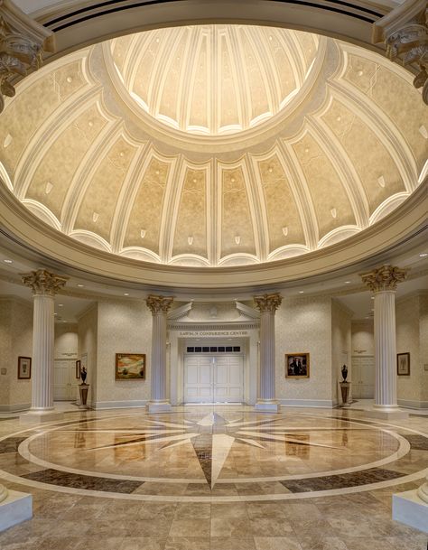 Towne University's interior’s grand entry centerpiece is a ceiling dome encircled with eight fluted Corinthian columns, all of which sit atop a granite and marble floor inlaid with a compass rose centerpiece. Photo (c) Studio SMW Corinthian Columns, Interior Design Sketchbook, Rose Centerpiece, Ceiling Domes, Dome Building, Grand Entry, Granite And Marble, Dome Ceiling, Glass Building