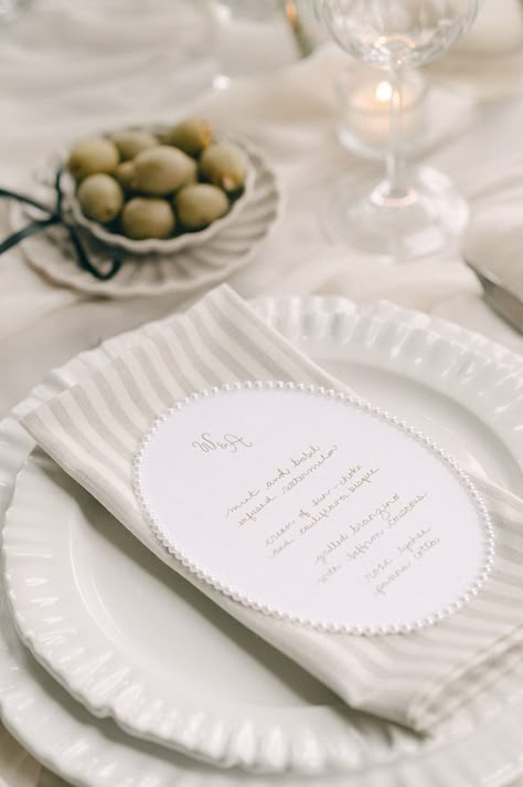 For something truly unique, have pearls surounding your wedding menu. It makes for the perfect pearl and neutral place setting. Add a striped napkin too!  Photographed by Alix Gould. Napkin On Plate Setting, Striped Napkins Wedding, Wedding Place Setting No Plate, Fabric Napkin Folding Ideas, Napkin And Menu Place Setting, Napkin Ideas For Wedding, Napkin Fold Wedding, Neutral Place Setting, Wedding Napkin Folding