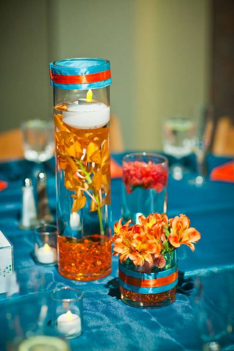 Centerpiece...change the turquoise to royal blue... Blue Floral Centerpieces, Orange Cake Design, Wedding Blue Flowers, Orange Wedding Centerpieces, Orange Decorations, Blue Orange Weddings, Orange Centerpieces, Blue Wedding Centerpieces, Book Themed Wedding