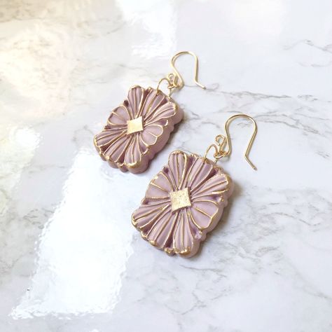 Introducing our exquisite purple clay earrings, the perfect accessory to complement your wedding day ensemble with timeless elegance. Crafted with utmost care and attention to detail, these stunning earrings feature a soft, neutral hue that effortlessly blends with any wedding theme and attire. The beige clay showcases a subtle, organic texture, adding a touch of natural charm to your overall look. The delicate design exudes sophistication, making these earrings a delightful choice for brides an Elegant Clay Earrings, Delicate Bridal Earrings, Earrings For Wedding, Polymer Clay Flower Jewelry, Polymer Clay Jewelry Tutorials, Handmade Clay Jewelry, Earrings Inspiration, Delicate Design, Handmade Jewelry Diy