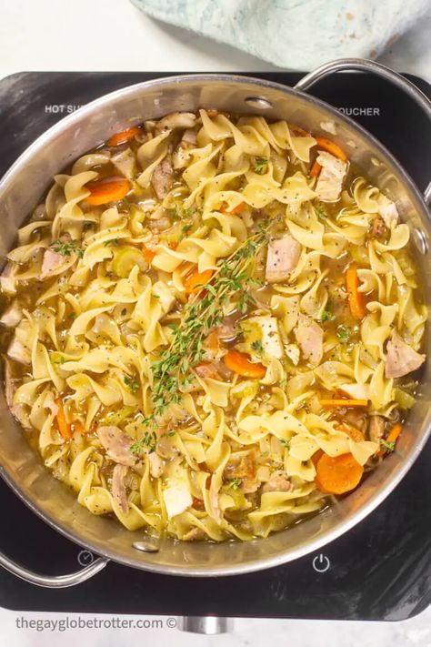 This easy leftover turkey noodle soup recipe uses leftover turkey and homemade turkey stock for a delicious winter soup! #gayglobetrotter #turkey #soup #turkeysoup #turkeynoodlesoup #souprecipe Turkey Soup From Carcass Recipes With Barley, Turkey Soup From Carcass Recipes, Leftover Turkey Noodle Soup, Turkey Soup From Carcass, Homemade Turkey Soup, Turkey Chops, Leftover Turkey Soup, Turkey Noodle Soup, Leftovers Soup