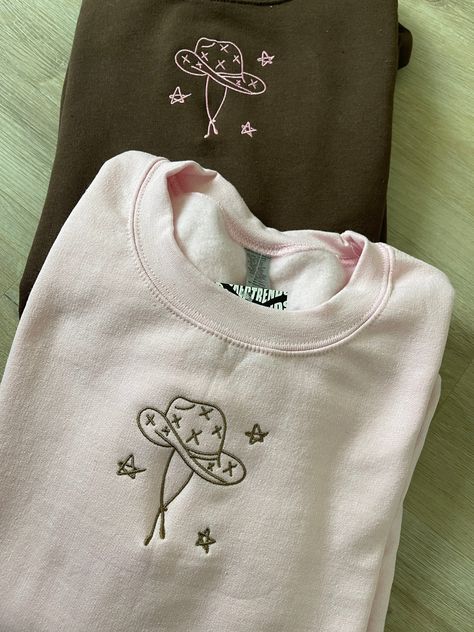 ✰COMES WITH TWO! Photo features: Brown Sweatshirt X Pink Thread // Pink Sweatshirt X Brown Thread ✰Embroidered Matching Sweatshirts✰UNISEX✰Hand drawn and designed✰Super soft and comfy! *Sizes 2XL-3XL may be subject to longer processing times since we don't carry a large amount of inventory in those sizes, so we would have to put in a special order from our supplier! Thank you for understanding. Brown Embroidery Designs, Cowboy Sweatshirts, Hoodie Embroidery Ideas, Embroidery Designs Sweatshirt, Hand Embroidery Sweatshirt, Cowboy Hat Embroidery, Diy Hoodies, Hand Embroidered Sweatshirt, Cowboy Star