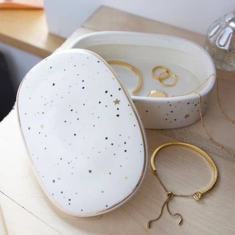 A super sweet pot to store precious trinkets and jewelry pieces, this ceramic box would look beautiful in any room of the house. With a speckled paint design which covers the ceramic in dots and stars, it's lift off lid is completed with a metallic rim. A pretty piece of homeware to decorate any bedside table or beauty desk. Dimensions: width 15.5cm x height 5cm x depth 10.5cm; inside height - 3.5cm Ceramic Box Ideas, Beauty Desk, Ceramic Moon, Ceramic Jewelry Box, Clay Box, Ceramic Box, Lisa Angel, Ceramic Products, Vert Turquoise