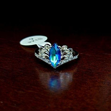 From The Fragrant Jewels Collection "Believe In Fairies" A Shining Green/Blue Crystal Is Centered On The Ring With Clear Cz Stones Surrounding It In A Beautiful Crown Shape! Believe In Fairies, Fragrant Jewels, Fairy Ring, Jewels Rings, Cz Stone, Blue Crystals, Womens Jewelry Rings, Blue Green, Crown