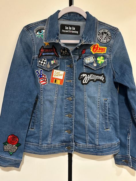 "Rock band patch jean jacket - brand new, one-of-a-kind. Screams Rock'n'Roll!  Hi, I'm Lindsey Gonzalez-Prada, the creator of LALA NOT LISTENING one-of-a-kind, rock 'n' roll jean jackets. LNL was born after curating my own jean jacket and receiving literally hundreds of compliments and inquiries from women and men (young and old) wherever I wore it! Everyone will be asking you too where you got this rad, edgy jacket!  This jacket is a Size Small and includes 15 patches and one enamel pin carefully selected and arranged artfully by me, the curator.  About the denim:  - Comfort stretch fabric - Button front closure - Button flap chest pockets and welt pockets at waist - Banded hem with adjustable button tabs at back waist - Buttoned cuffs - Sustainable low impact wash - Content: 68% Cotton | Patch Jean Jacket, Denim Jacket With Patches, Edgy Jacket, Jean Jacket Patches, Rolled Jeans, Band Patches, Not Listening, Jacket Ideas, Denim Jacket Patches