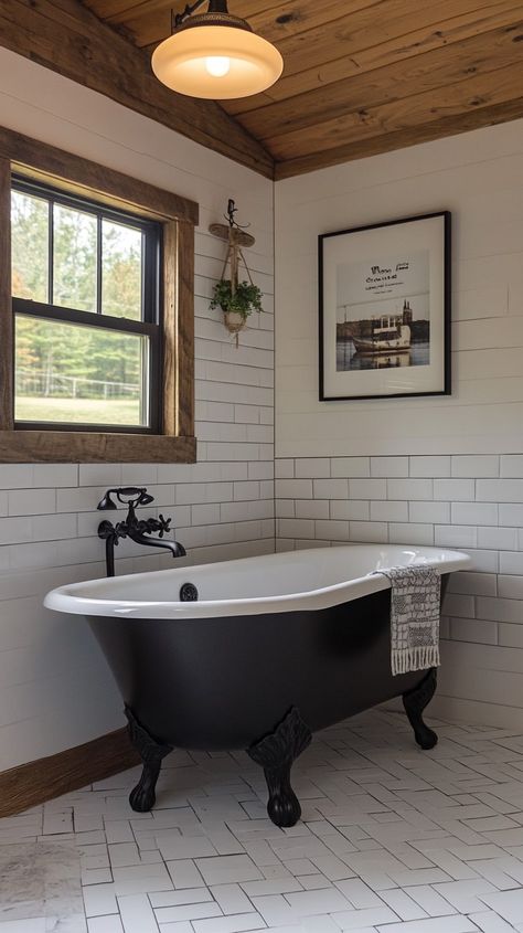 Small bathroom featuring a black claw-foot tub, herringbone tile floor, wood ceiling, and modern farmhouse decor. White Herringbone Tile Floor, Herringbone Tile Floor, Small Bathroom Solutions, White Herringbone Tile, Clever Storage Ideas, Herringbone Tile Floors, City Bathrooms, Farmhouse Bathroom Ideas, Bathroom Retreat