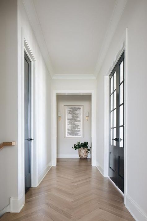 Transitional mudroom hallway finished with oak herringbone wood floors and black closet doors. Transitional Mudroom, Mudroom Hallway, Herringbone Wood Floor, Herringbone Wood, White Oak Hardwood Floors, Hallway Flooring, Oak Hardwood Flooring, Herringbone Floor, White Oak Floors