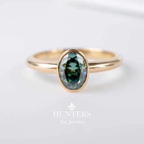 🌟 Introducing our newest addition: Oval Teal Green Moissanite Solitaire Bezel Ring! 💍 Crafted from solid 9ct yellow gold, this ring exudes elegance and sophistication. Each ring is hallmarked with full British assay marks and our own mark, guaranteeing its quality and authenticity. Available sizes: M and P 💎 Moissanites are renowned for their strength and durability, ensuring this ring will be cherished for a lifetime. DM me with any questions! Michael :) #MoissaniteRing #TealGreen #... Green Moissanite, Modern Jewellery Design, Bezel Ring, Moissanite Jewelry, Contemporary Jewellery, Moissanite Rings, Teal Green, Bezel Setting, Solitaire Ring