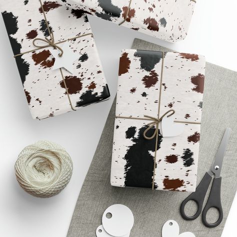 "Saddle up, partner! Wrangle in the Wild West charm with our Cowhide Western Wrapping Paper. Crafted with black, brown, and white cowhide, this ruggedly stylish paper is perfect for wrappin' up gifts at western-themed bashes, rodeos, and cowpoke celebrations. Yeehaw! Whether you're a rancher, farmer, or a rootin' tootin' cowboy or cowgirl, this paper will add a touch of frontier flair to your presents. So giddy up and lasso the perfect gift presentation with our Cowhide Western Wrapping Paper, w Western Wrapping Paper, Booth Aesthetic, Paper Cow, Cow Print Birthday, Cowboys Gifts, Rootin Tootin, Green Wrapping Paper, Cowboy Gifts, Western Shop