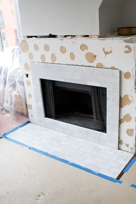 Our fireplace makeover is coming along! We added marble subway tile to the hearth and fireplace surround for a classic and clean look. Here's how to tile a fireplace and the pre-mixed grout that was such a gamechanger! #tile #marbletile #marblesubwaytile #DIYfireplace #tilefireplace #DIY #howto #tutorial Subway Tile Fireplace, White Stone Tiles, Marble Subway Tile, Fireplace Marble, White Built Ins, Natural Stone Fireplaces, Marble Subway Tiles, Tile Fireplace, Makeover Tips