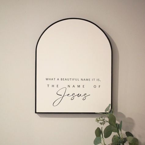 "**Sign comes with phrase \"What a beautiful name it is, the name of Jesus\". ** You choose the sign color (Black, white, smokey beige) as well as the leather frame color (Black, Cognac (tan * 15\"H x 12\"W x 1\"D * Handmade wood sign * Constructed from treated 3/4\" plywood * Sign is pictured in **Matte white paint/Black lettering/Tan leather frame** **Every sign we create is handmade from start to finish, so there will be variations in texture, technique and overall appearance. We use 3/4\" ma Jesus Home Decor, Plywood Sign, Arch Sign, Jesus Decor, What A Beautiful Name, Bible Wall Art, Beautiful Name, Leather Frame, Paint Black