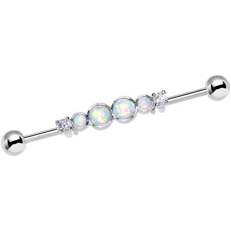 PRICES MAY VARY. 14 gauge industrial piecing jewelry 1 7/16 inch; 36 millimeters barbell length Durable 316L stainless steel cartilage barbell earring Features moveable centerpiece of white synthetic opals and clear accents To wear as helix piercing simply insert each end of the barbell into each hole The shimmering glamour of this industrial barbell earring features a quartet of white synthetic opals cushioned between a clear accent on each side in the middle of the barbell. The 36mm long strai Piercing Reference, Industrial Barbell Jewelry, Bar Ear Piercing, Industrial Earring, Opal Body Jewelry, Industrial Bars, Industrial Piercings, Industrial Piercing Barbells, Ear Piercings Industrial