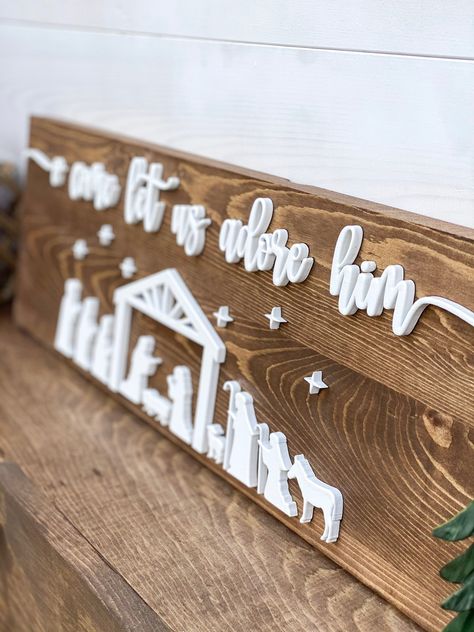 "Complete your holiday home decorating with this one of a kind Nativity Scene Sign that says \"O Come Let Us Adore Him\". This cute farmhouse sign comes with 3D lettering and will be a perfect addition to your Christmas Decor this holiday season or as a special Christmas gift for friends and family. Specifications: Size is 8x24 Medium Walnut Stained board with White 3D Lettering Production & Shipping: Please allow 2 weeks for production and 1 week for shipping." Cricut Farmhouse Signs Wood, Wood Holiday Signs, Nativity Wood Sign, Come Let Us Adore Him Sign, Christmas Plaques Ideas, O Come Let Us Adore Him Sign, Family Christmas Sign, Xtool M1 Project Ideas Christmas, Christmas Glowforge Ideas