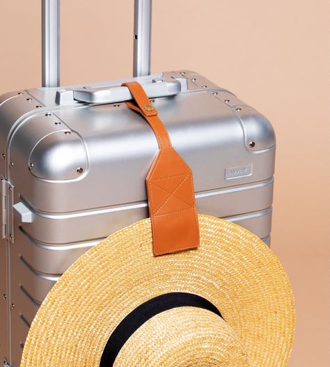 A magnetic clip to secure your hat to your suitcase while you're on the go! by Lindsay Albanese Brown Travel Accessories With Leather Trim, Hat Travel Case, Travel Hat Clip, Suitcase Keychain, Leather Luggage Tag With Sleeve For Gift, Swell Bottle, Spf Lip Balm, Simple Scarf, Travel Pants