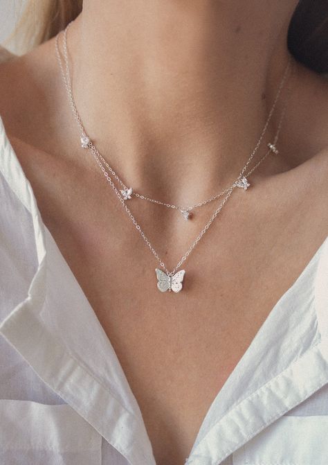 This set consists of 2 sterling silver necklaces, both of which feature butterfly pendants and are fastened at the center back with a round spring clasp, and have a short extension chain. It has: ✅ A delicate chain necklace with a single butterfly pendant attached to the center front of the chain, with intricate detailing on the wings and body ✅ A delicate chain necklace with 5 small butterfly pendants attached to the center front, each pendant made from four zirconia stones.  A dainty and classy duo that will elevate any outfit, including your everyday jeans and tees. Details: ✅ Material: 925 sterling silver, cubic zirconia ✅ Butterfly necklace - length: 42.0 cm (16.53 inches) + 5.0 cm (1.96 inches) length extension; weight: 5.0 g (0.17 oz) ✅ Gemstone multi charm butterfly necklace - leng Womens Necklaces Silver, Butterfly Necklace Silver, Pretty Jewelry Necklaces, Small Butterfly, Dr Shoes, Butterfly Pendant Necklace, Butterfly Jewelry, Fancy Jewelry, Cute Necklace