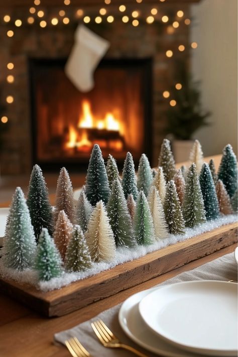 This snowy pine forest centerpiece is a must-try for your holiday decor. Mini trees of different heights grouped on a tray and dusted with faux snow create a magical scene. It’s simple, easy, and so charming—don’t you love how festive it feels? Mini Tree Christmas Centerpiece, Mini Christmas Tree Display, Snowy Forest Christmas Decor, Bottle Brush Trees Centerpiece, Winter Forest Decor, Winter Party Table Decor, Christmas Forest Decor, Small Christmas Trees On Table, Bottle Brush Tree Centerpiece