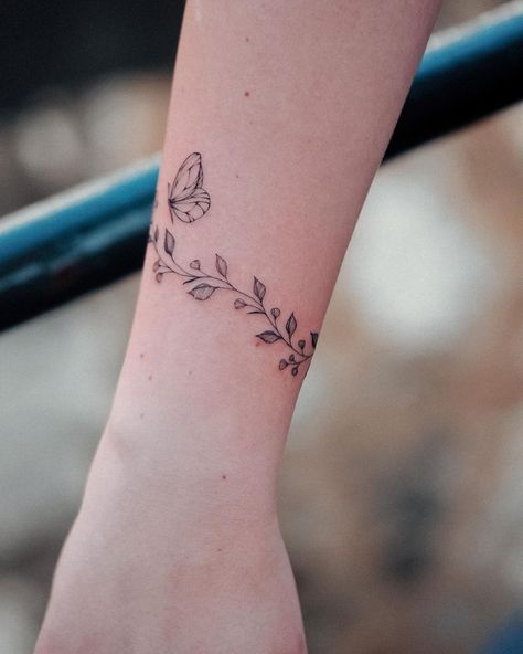 Dainty Flower And Butterfly Tattoo, Butterfly Tattoo Bracelet, Butterfly Band Tattoo, Butterfly Bracelet Tattoo, Bunami Ink, Wrap Around Wrist Tattoos, Butterfly With Flowers Tattoo, Butterfly Wrist Tattoo, Butterfly Tattoo Meaning