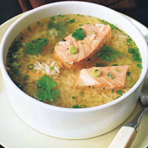 A quick-to-make meal-in-a-bowl, this soup is inspired by similar one-dish wonders popular in China, Thailand, and Japan. The rice is sometimes cooked ... Salmon Soup, Asian Salmon, Ginger Salmon, Rice Soup Recipes, Salmon And Rice, Fish Soup, Easy Asian, Seafood Soup, Asian Soup