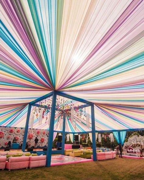 Photo By Occasions - Decorators Indian Wedding Carnival Theme, Pastel Mehendi Decor Ideas, Shadi Vala Ghar Board Ideas, Carnival Decorations Ideas Entrance, Pastel Theme Haldi Decor, Pastel Event Decor, Open Wedding Decoration, Wedding Tents Outdoor, Wedding Home Decoration Indian Exterior