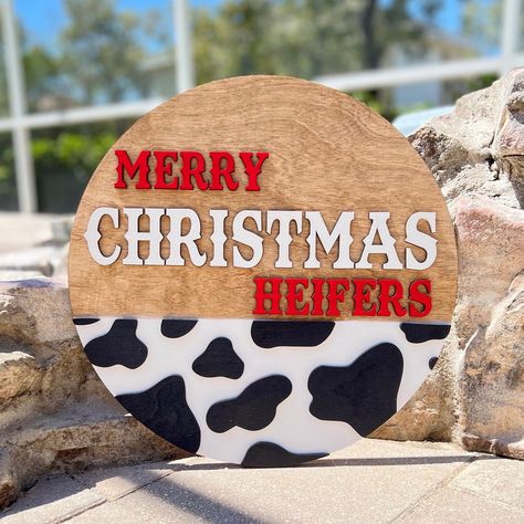 Merry Christmas Heifers!  Are you a cow lover? This makes the perfect addition to your front door!  ~ Cut from 1/4" birch wood. The sign is layered making it 3D, NO vinyl is used ~ Twine attached to the back of the sign for hanging purposes PLEASE NOTE: ~ The back is left unfinished ~ Door hanger is for indoor/outdoor use. It is to be displayed on a covered front door or porch. We recommend avoiding placing the hanger in direct sunlight as it could cause fading overtime ~ Due to us working with Cow Christmas Door Hanger, Simple Christmas Door Hangers, Western Door Hangers, Christmas Door Hangers Diy, Christmas Door Hangers Wooden, Winter Door Hangers, Christmas Decor Front Porch, Christmas Door Signs, Front Door Hangers