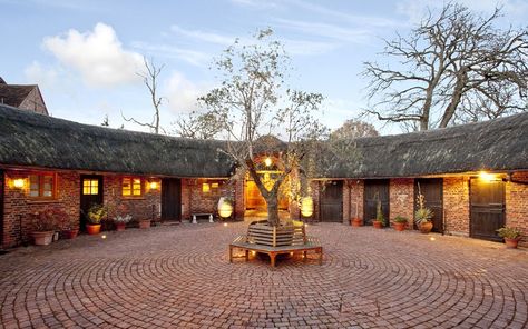 Low on maintenance and high in atmosphere, courtyards are the perfect place to   relax. Horse Stables With Courtyard, Courtyard Stables, Stable Courtyard, Mansion With Horse Stables, Horse Stable Aesthetic Exterior, Brick Stables Equestrian, Stable Yard, Stable Block, Small Barns