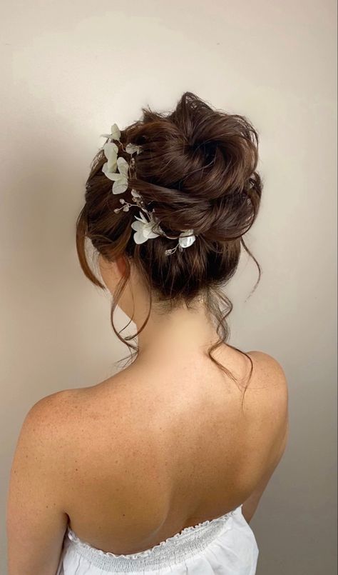 Flower Hairdo Wedding, Curly High Bun Wedding, Wedding Bun Flowers, Textured High Bun Wedding, Bun Flower Hairstyles, Quince High Bun Hairstyles, Wedding Hairstyle High Bun, Bridesmaid High Bun Hairstyles, Prom Hairstyles High Bun