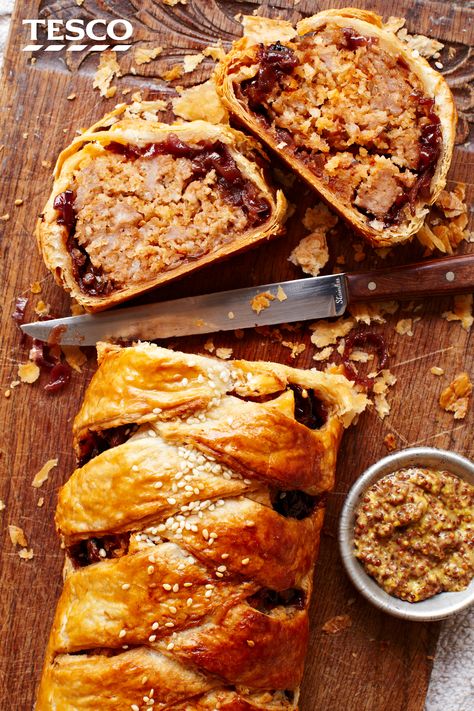 Feast your eyes and fill up on this better-sized sausage roll. A pretty plait of golden, crispy pastry filled with herby sausage meat and sweet caramelised onions makes this savoury showstopper the ideal centrepiece for any festive buffet. | Tesco Sausage Plait, Caramelised Onions, Sausage Roll, Tesco Real Food, Savoury Baking, Sausage Rolls, Onion Recipes, Family Food, Bacon Recipes