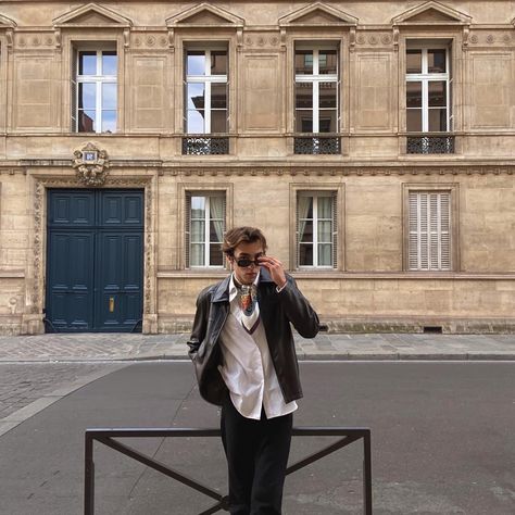 Hi, I’m Pierre, I’m a student and I live in #Paris I really like #vintage #fashion with a little spice. I like to keep it simple and casual. I’d like to share it with you so come join me on my #instagram account to get to know me more ! Here I’m wearing a Leather Jacket with a Scarf. White shirt underneath. Black glasses to tie everything together. I said casual and simple for a good sunday ✨ #leatherjacketoutfit #leatherjacket #outfit #mensclothing #mensfashion #aesthetic #oldmoney #oldmon Old Money Leather Jacket Outfit, White Shirt And Leather Jacket, Old Leather Jacket Outfit, Leather Jacket Old Money, White Shirt Leather Jacket, Stand Pose, Leather Jacket Outfit Men, Live In Paris, English Accent