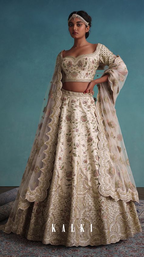 "This lehenga has a scalloped hem and is embroidered in zardosi, beads, resham, threadwork, french knots, and sequins with a side zip, side hook, and side tassel dori closure. 
The blouse comes with a fully embroidered blouse in a sweetheart neckline, half sleeves, and a side zip with tassel dori.
The lehenga is paired with a matching net dupatta with a heavy embroidered scallop border with buttis all over. Scallop Lehenga, Sari India, Latest Bridal Lehenga Designs, Heavy Lehenga, Floral Hand Embroidery, Wedding Trousseau, Party Wears, Latest Bridal Lehenga, French Knot Embroidery