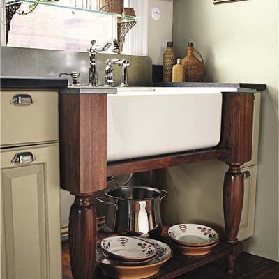 The custom washstand designed to hold the Rohl fireclay farm sink has turned legs, with open storage down below for frequently used pots and serving pieces. A zinc countertop and a Delta faucet with Victorian styling complete its old-fashioned look. Free Standing Kitchen Sink, Kitchen Sink Diy, Redo Kitchen Cabinets, Trendy Farmhouse Kitchen, Farmhouse Kitchen Sink, Freestanding Kitchen, Kitchen Stand, Farm Sink, Small Space Kitchen