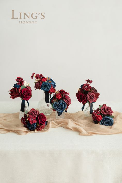 Wedding Floral Centerpiece set in burgundy and navy. Elevate your wedding table decor with an elegant centerpiece of burgundy and navy flowers. This centerpiece is designed with lots of delicate floral, filler flowers, and interesting greenery, with natural shapes and a variety of textures Navy Blue Wedding Decorations, Burgundy Ranunculus, Avalanche Rose, Black Baccara, Elegant Wedding Colors, Navy And Burgundy Wedding, Blue Wedding Decorations, Indoor Wedding Receptions, Wedding Renewal