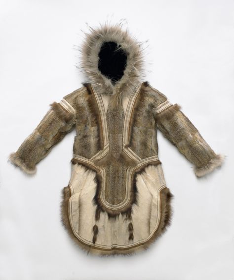 The upper body was sewn from arctic ground squirrel pelts and the rounded lower apron is white reindeer or caribou fur. The dark trim and tassels are wolverine fur and the hood has a wolf hair ruff. Inuit Clothing, National Museum Of Natural History, Dark Trim, White Reindeer, Inuit Art, Museum Of Natural History, Native American Art, First Nations, National Museum