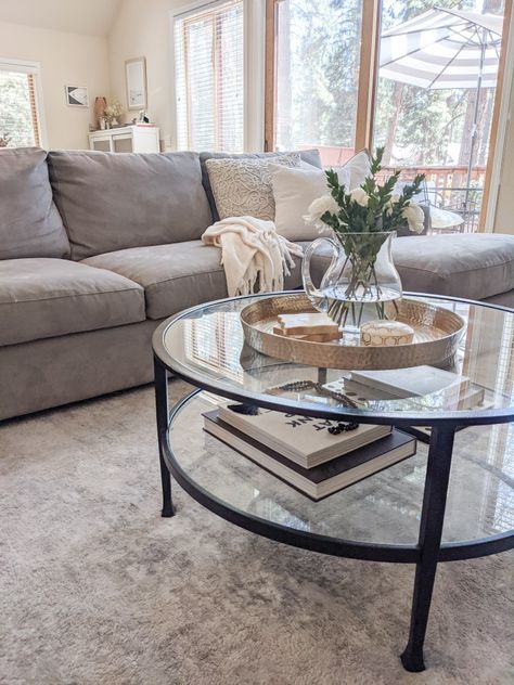 Coffee Table With Grey Sectional, Black Glass Coffee Table Living Room, Glass Table Living Room Decor, Grey Couch With Coffee Table, Black Glass Table Living Rooms, Circle Glass Coffee Table Decor, Grey Couch Coffee Table Ideas, Glass Black Coffee Table, Living Room Black Table