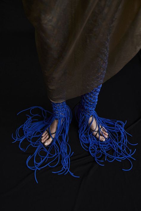 A macrame hand-knitted trousers with fringe edges, lined with metal hoops. Crafted from Macrame Jersey Knit in blue. #lookbook #fashion #contemporary #aesthetic #photography #model Photography Model, Aesthetic Photography, Blue Fashion, Knit Jersey, Hand Knitting, Macrame, Lookbook, Trousers, Fashion Outfits