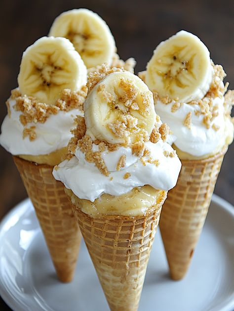 Banana Pudding Cheesecake Cones  𝗜𝗻𝗴𝗿𝗲𝗱𝗶𝗲𝗻𝘁𝘀 🍦  For the Cheesecake Filling: 2 (8 oz) packages cream cheese, softened 1 cup granulated sugar 1 tsp vanilla extract 1 cup sour cream 1 cup heavy cream 1/2 cup banana puree (about 2 ripe bananas) 1/2 cup crushed vanilla wafers 1/2 tsp ground cinnamon (optional) For the Banana Pudding: 2 cups whole milk 1/2 cup granulated sugar 1/4 cup cornstarch 1/4 tsp salt 1 tsp vanilla extract 2 ripe bananas, sliced Cheesecake Cones, Banana Puree, Pudding Cheesecake, Cheesecake Squares, Banana Pudding Cheesecake, Cheesecake Filling, Ripe Bananas, Vanilla Wafers, Banana Pudding