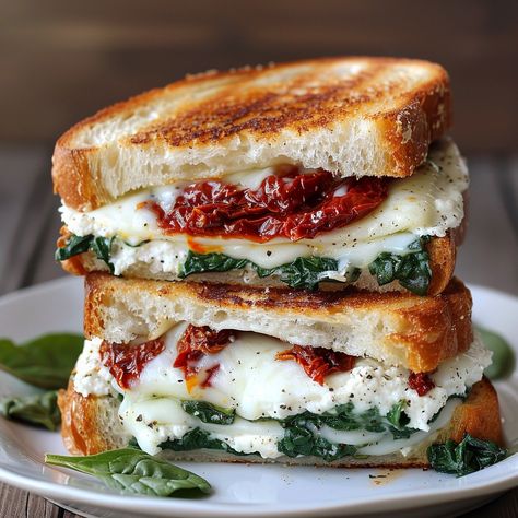 🍅🧀 Try our Sun-Dried Tomato, Spinach, and Ricotta Grilled Cheese! #GrilledCheese #GourmetSandwich Sun-Dried Tomato, Spinach, and Ricotta Grilled Cheese Ingredients: Sourdough bread (4 slices) Ricotta cheese (1/2 cup) Sun-dried tomatoes (1/4 cup, chopped) Fresh spinach (1 cup) Mozzarella cheese (1 cup, shredded) Butter (2 tbsp) Instructions: Spread ricotta cheese on two slices of bread. Layer with sun-dried tomatoes, spinach, and mozzarella cheese. Top with the remaining bread slices. Heat... Ricotta Grilled Cheese, Panini Ideas, Spinach And Mozzarella, Tomato Spinach, Spinach And Ricotta, Sourdough Sandwich, Lunch Inspiration, Gourmet Sandwiches, Instagram Recipes