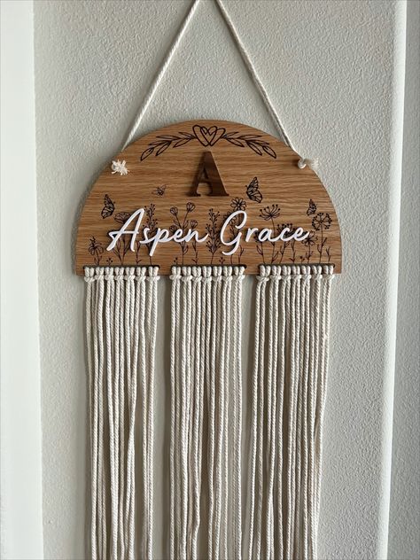 This is our newest board to our site.  A larger version of our very popular Personalized Oak Boho Macrame Bow Holder.

Dimensions: approximately 11 3/4 inches wide and 6 3/4 inches tall (before macrame). 

1/8th inch Oak wood.

Initial is laser cut from Walnut wood.

Name laser cut from white acrylic.  

Laser engraved wildflowers, butterflies and heart embellishment on the front. 

Bow holder includes (21) 4mm Macrame cords that are 21 inches in length.   
Your choice of 1, 2 or 3 colors. Macrame Bow Holder, Macrame Bow, Macrame Cords, Bow Holders, Hair Bow Holder, Boho Macrame, Bow Holder, Macrame Cord, White Acrylic