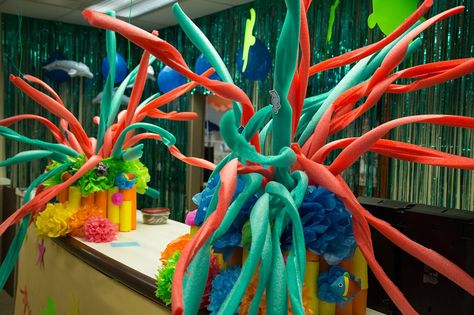 While you are planning your decorations for your ocean-themed VBS this summer, here is a DIY idea you could consider. By making some “swirling cuts” on a standard pool noodle, you can make an inexpensive and fun coral decoration. Pool Noodle Coral Reef, Pool Noodle Coral, Under The Sea Christmas, Deep Sea Discovery Vbs, Surf Shack Vbs, Ocean Commotion Vbs, Vbs Ocean Theme, Submerged Vbs, Ocean Vbs