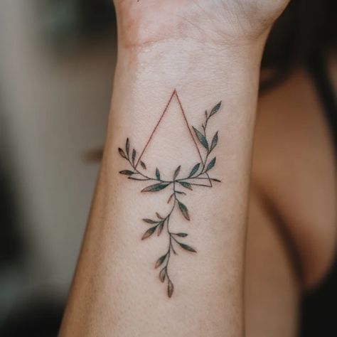 Minimalistic tattoo of a triangle with surrounding leafy branches on a forearm. Cool Triangle Tattoos, Triangle Flower Tattoo, Tattoos For Women Minimalist, Triangle Tattoo Meaning, Tattoo Ideas For Females, A Small Tattoo, Arrow Tattoos For Women, Unique Tattoo Ideas, Triangle Tattoos