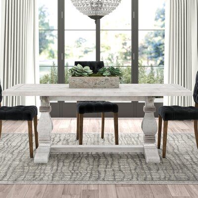 Gather the family around this traditional dining table for a tasty home-cooked (or take-out!) meal. It's made from solid pine wood and features a grey finish with rubbed-through details and human-made wormholes for a distressed look that creates rustic charm. The trestle base has two pedestal legs with turned details and offers you and your family plenty of legroom as you tuck in for dinner. Measuring 78" long, this dining table sits eight people comfortably. To assemble, simply attach the base. Wood Trestle Dining Table, Mango Wood Dining Table, Reclaimed Wood Sideboard, Traditional Dining Tables, Pine Dining Table, Trestle Dining Table, Hosting Dinner, Spacious Kitchen, Traditional Dining